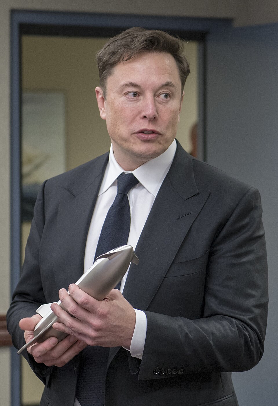 Elon Musk holding a model of SpaceX Starship in April 2019